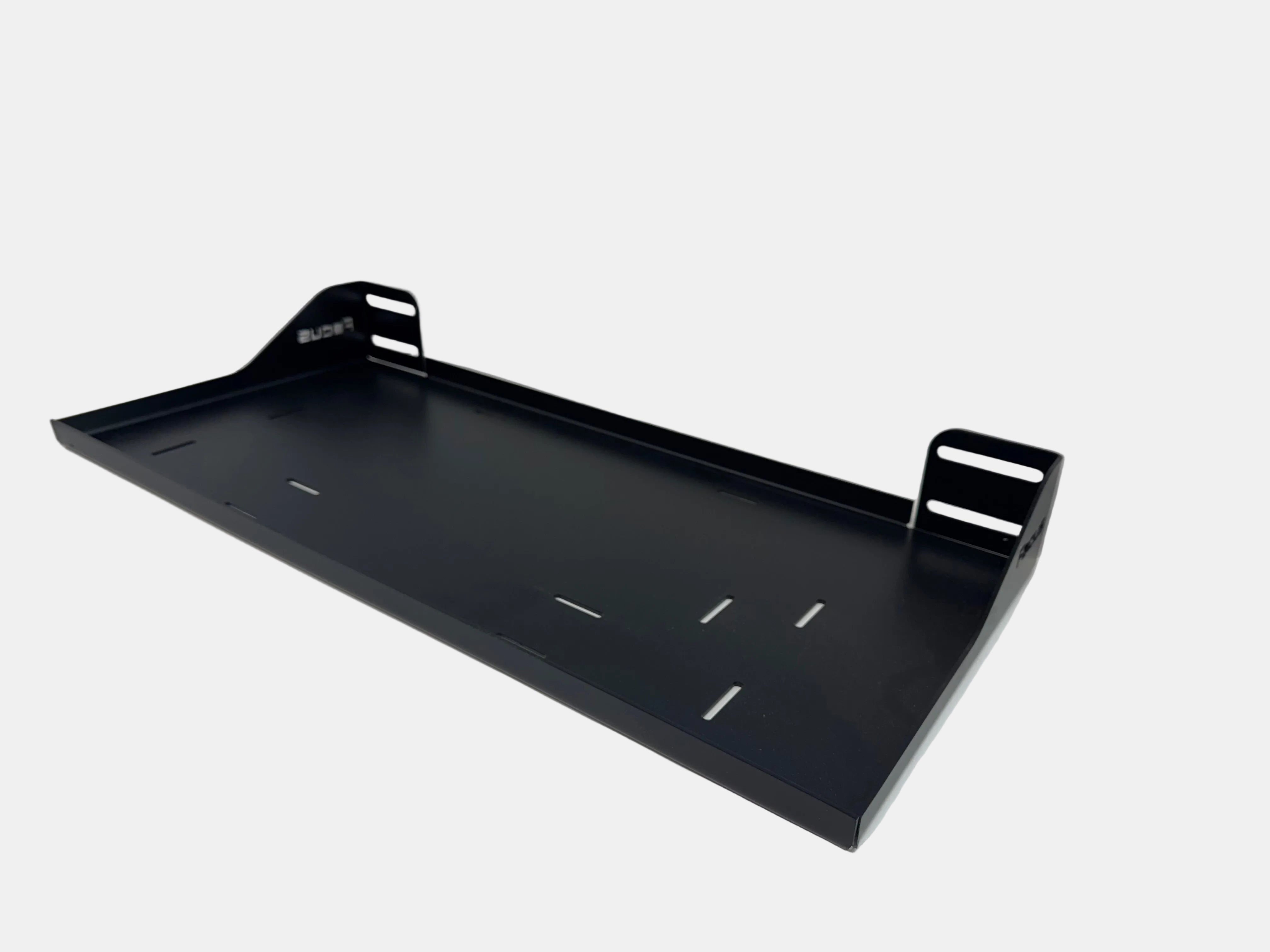 Black metal shelf or tray on a white surface with a neutral background