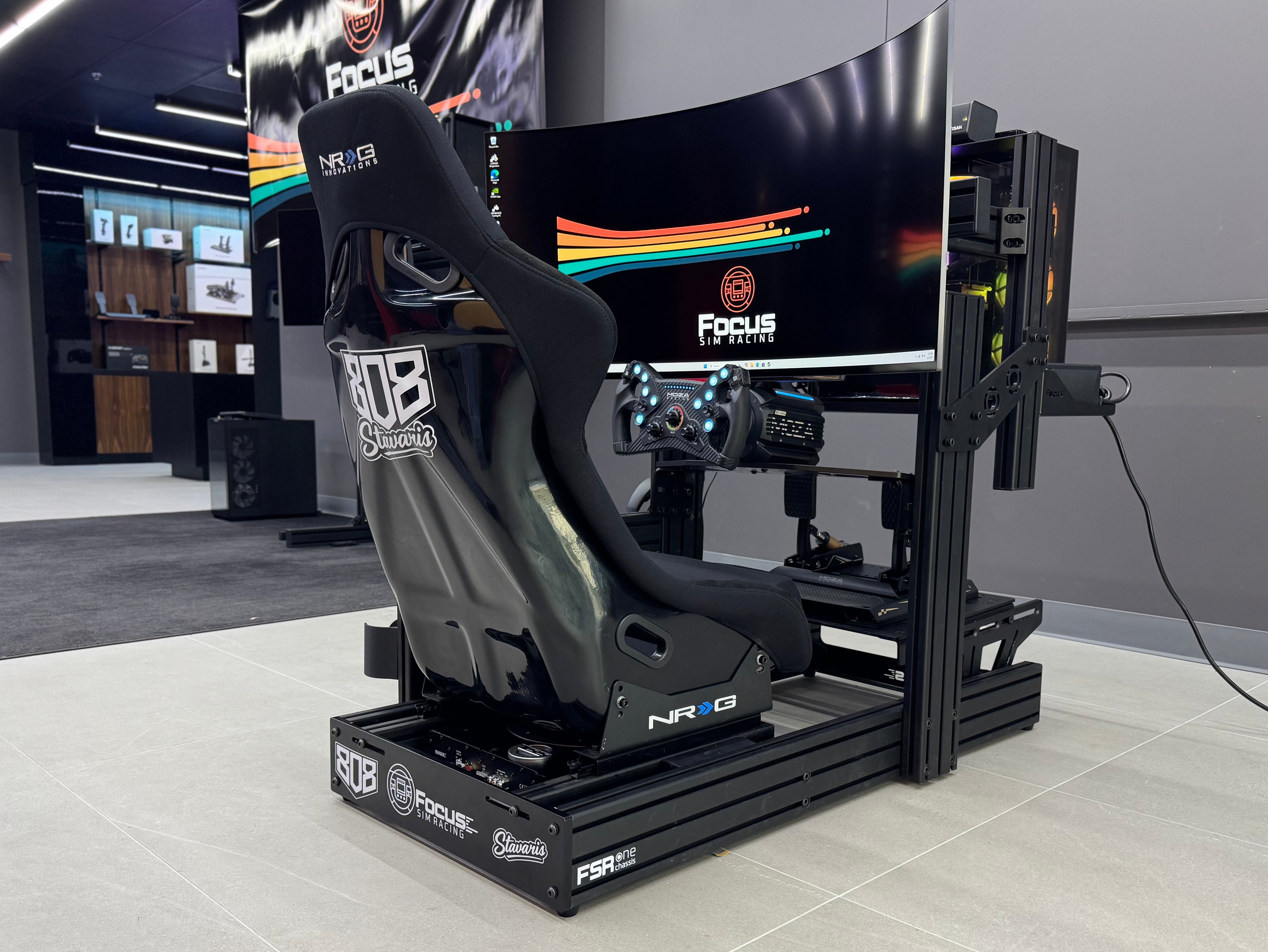 Simulator racing chair with multiple screens in a room setting