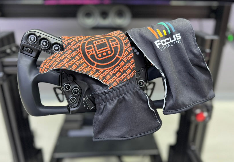 Focus Sim Racing gloves draped over a sim racing steering wheel