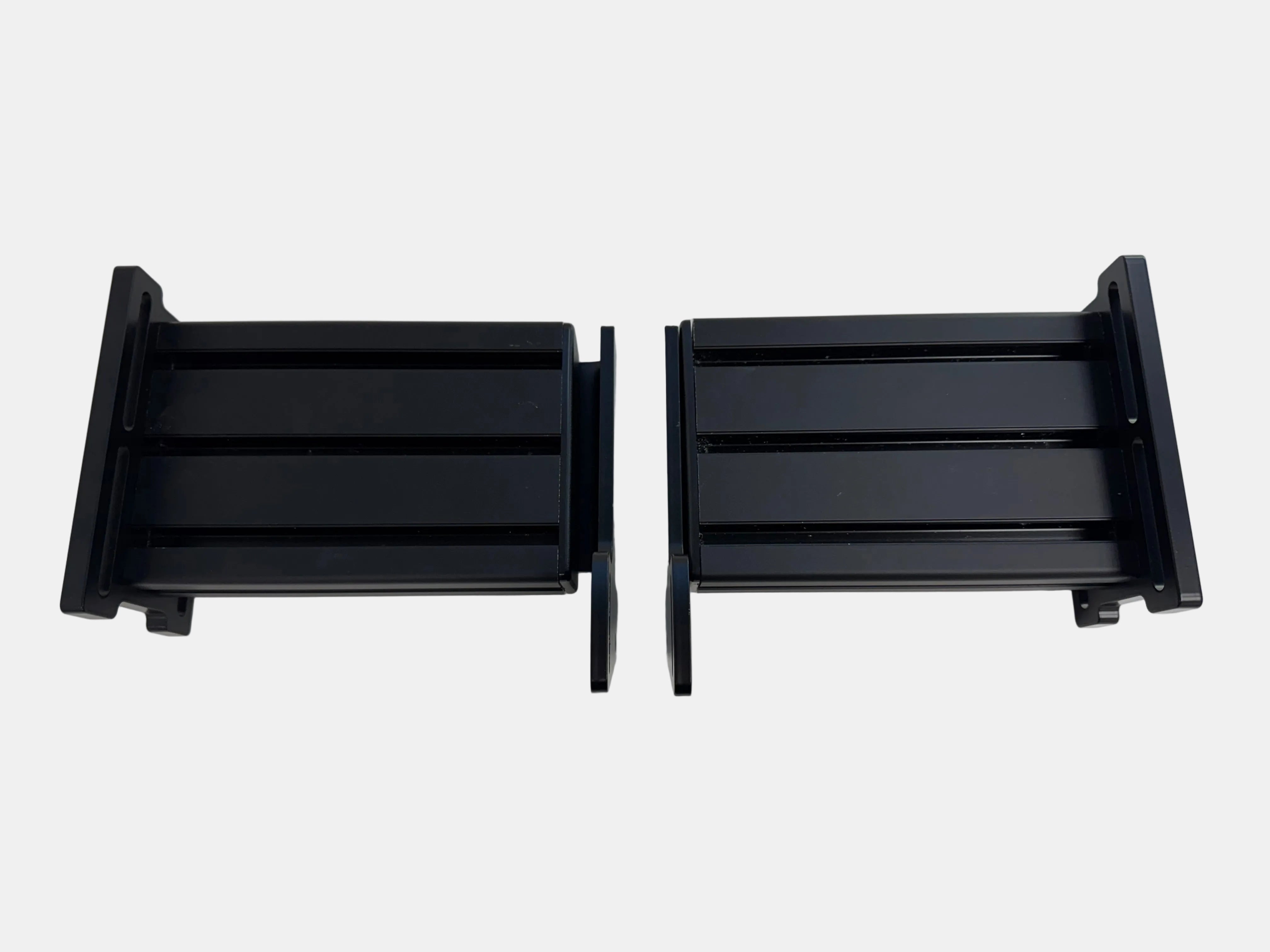 Two black metal brackets on a white background