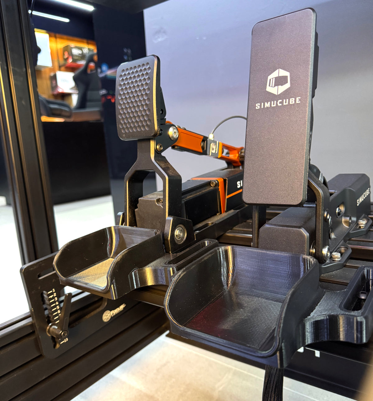 Two FSR heel cups installed in front of brake and throttle pedals on an aluminum extrusion cockpit